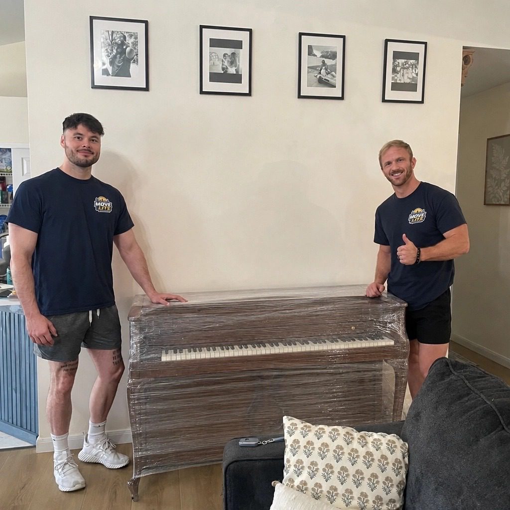 Move Lite piano moving crew standing next to spinet piano in St. Louis MO